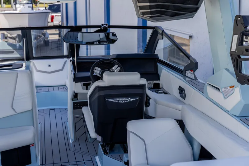 Slide: The Image of Interior of 2026 Nautique Super Air Nautique G23 boat, featuring modern helm and seating. - 17