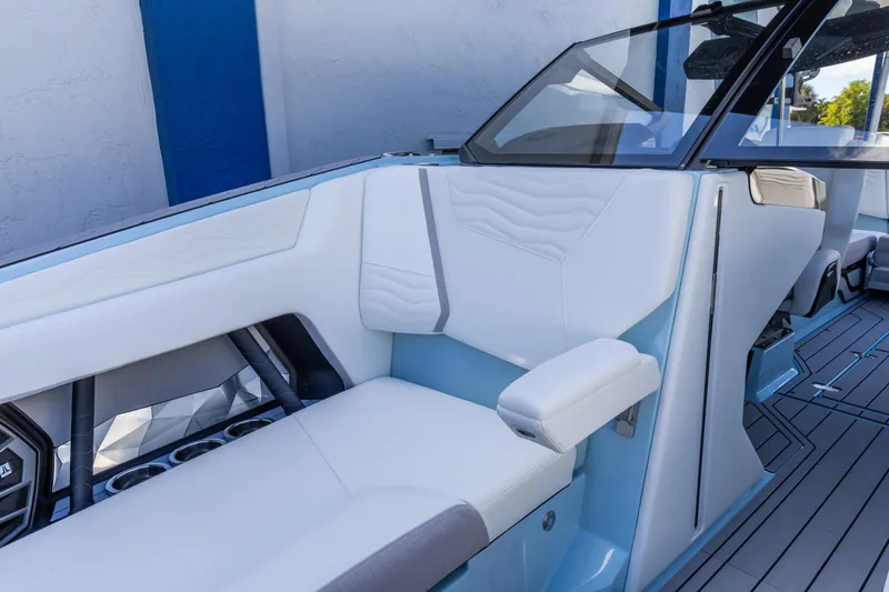 Slide: The Image of 2026 Nautique Super Air Nautique G23 interior with sleek white and blue seating. - 25