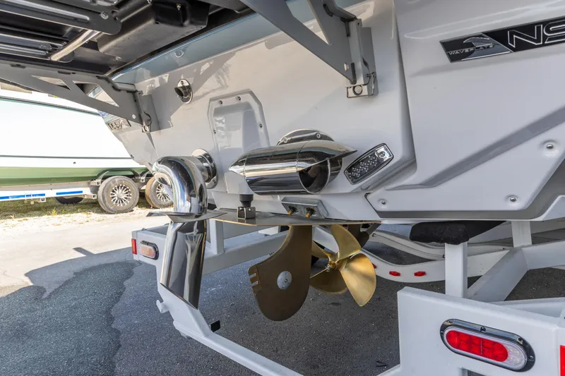 Slide: The Image of 2026 Nautique Super Air Nautique G23 boat stern with propeller and exhaust system. - 31