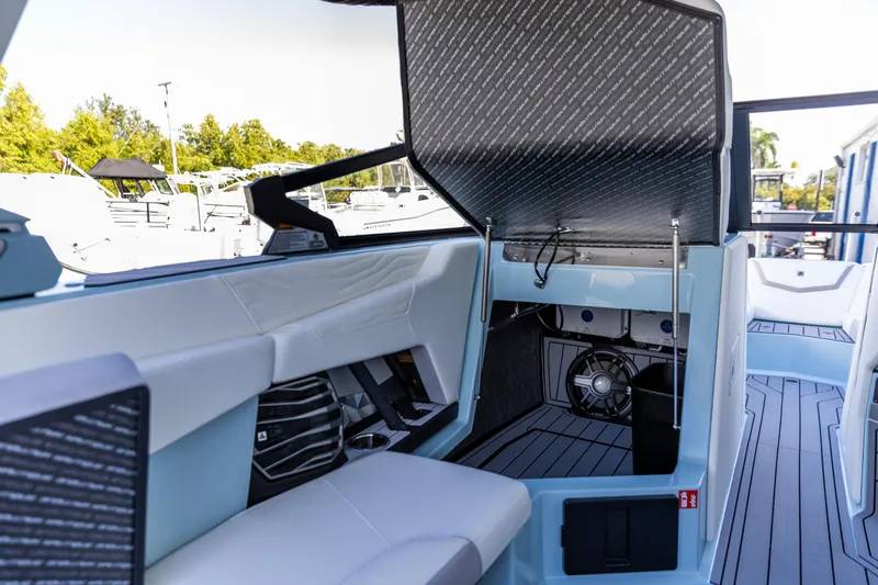 Slide: The Image of 2026 Nautique Super Air Nautique G23 interior with open storage compartment and sleek seating. - 7