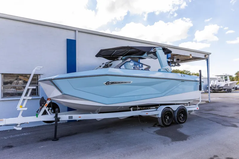Slide: The Image of 2026 Nautique Super Air Nautique G23 boat on trailer, parked outdoors. - 8