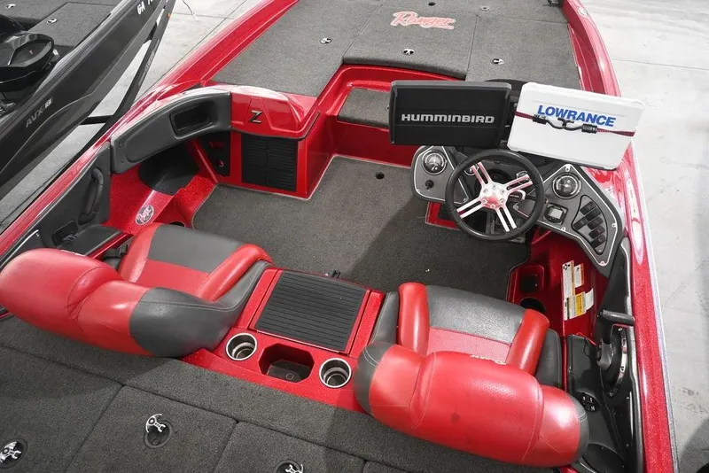 Slide: The Image of 2013 Ranger Z100 Z119 boat interior with red seats, steering wheel, and navigation systems. - 11