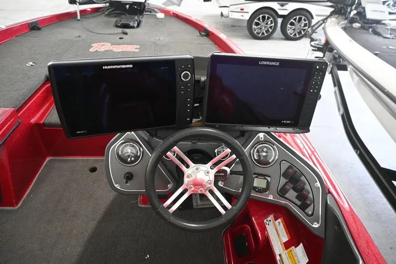 Slide: The Image of 2013 Ranger Z100 Z119 boat dashboard with dual fish finders and steering wheel. - 13