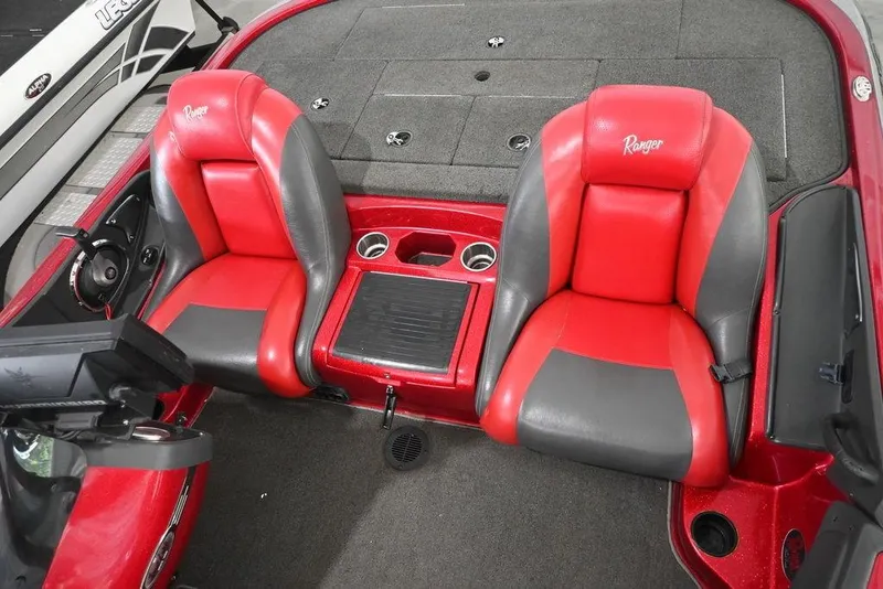 Slide: The Image of 2013 Ranger Z100 Z119 boat interior with red and gray seats, steering wheel, and console. - 7