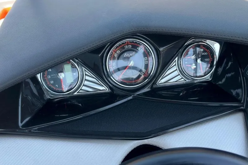 Slide: The Image of Dashboard of a 2015 Tigé RZ 2 boat with speedometer and gauges. - 14
