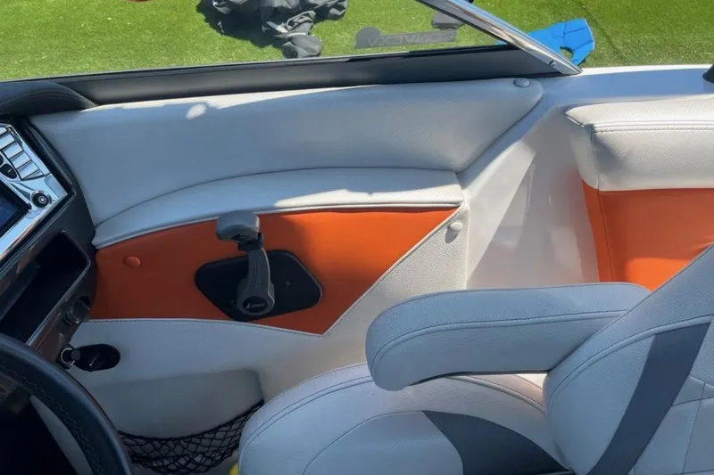 Slide: The Image of Interior of 2015 Tigé RZ 2 boat with orange and white seating. - 17