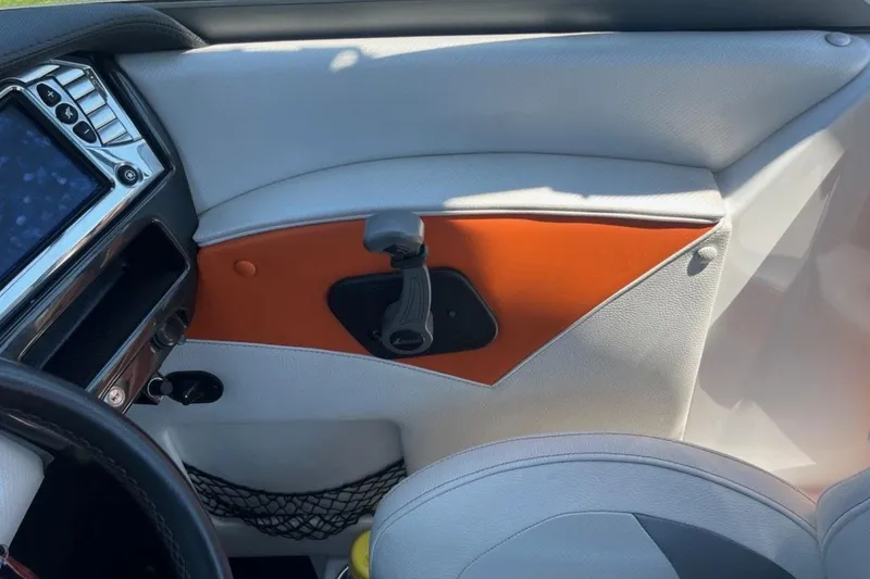 Slide: The Image of 2015 Tigé RZ 2 boat interior with modern dashboard and orange accents. - 18