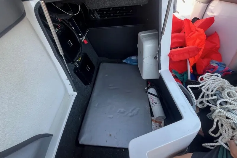Slide: The Image of 2015 Tigé RZ 2 boat storage area with life jackets, ropes, and fire extinguisher. - 19