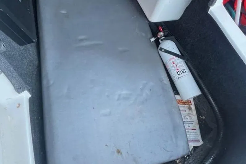 Slide: The Image of 2015 Tigé RZ 2 boat interior with fire extinguisher and storage area. - 20