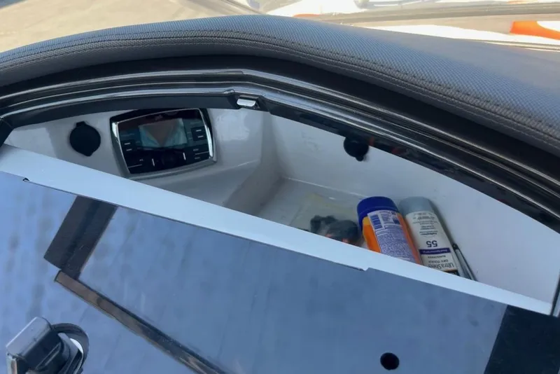 Slide: The Image of 2015 Tigé RZ 2 boat storage compartment with sunscreen and accessories. - 23