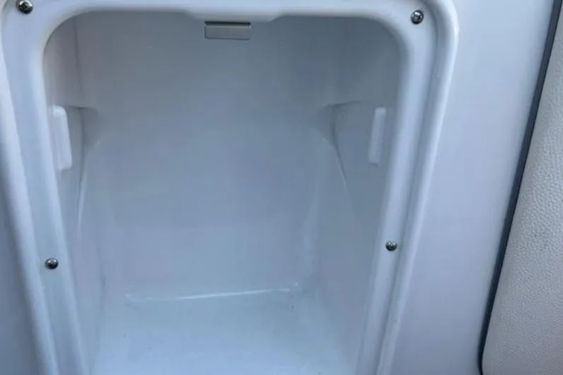 Slide: The Image of 2015 Tigé RZ 2 boat storage compartment, white interior, open and empty. - 25