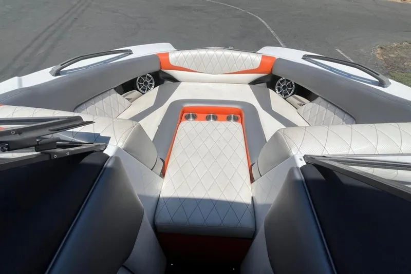 Slide: The Image of 2015 Tigé RZ 2 boat interior with diamond-stitched seating and cup holders. - 26