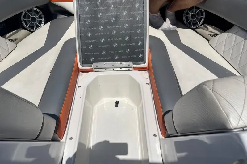 Slide: The Image of 2015 Tigé RZ 2 boat interior with open storage compartment and stylish seating. - 27
