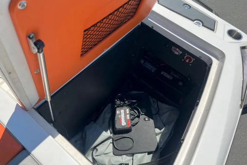 Slide: The Image of 2015 Tigé RZ 2 boat storage compartment with battery and charger. - 8