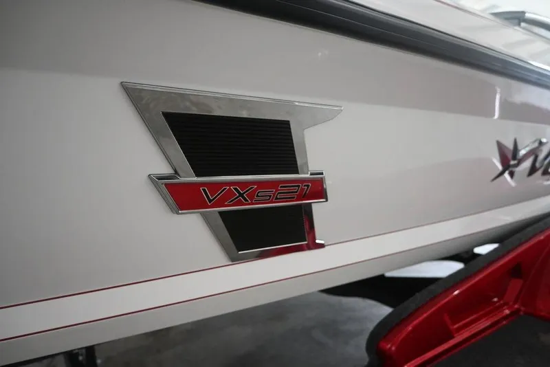 Slide: The Image of 2026 Vexus VX s21 boat emblem on sleek white exterior. - 2