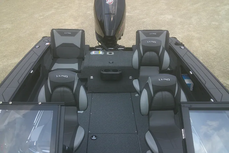 Slide: The Image of 2026 Lund 1875 Crossover XS boat interior with seating and motor. - 13