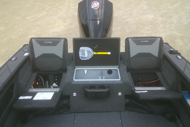 Slide: The Image of 2026 Lund 1875 Crossover XS boat interior with storage compartments and seating. - 14