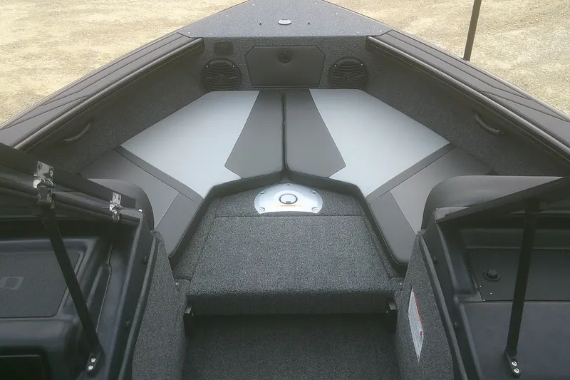 Slide: The Image of 2026 Lund 1875 Crossover XS boat interior with gray seating and storage compartments. - 4