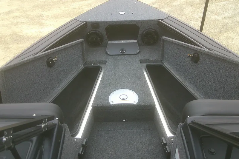 Slide: The Image of 2026 Lund 1875 Crossover XS boat interior with storage compartments and speakers. - 5