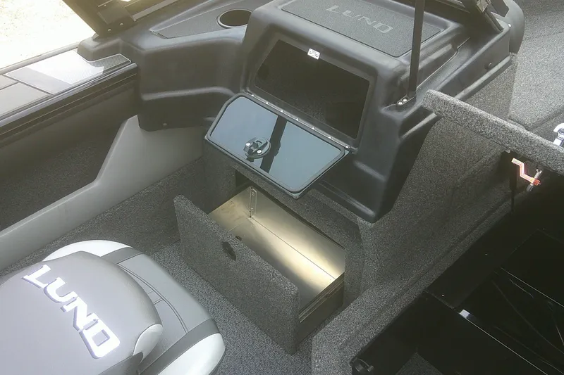 Slide: The Image of 2026 Lund 1875 Crossover XS boat interior with storage compartments and seating. - 7