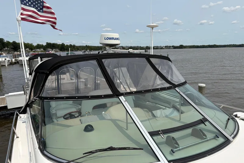 Slide: The Image of 2001 Sea Ray 460 Sundancer yacht docked, featuring a sleek design and American flag. - 10