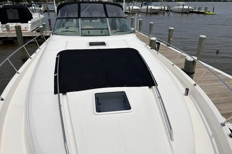 Slide: The Image of 2001 Sea Ray 460 Sundancer yacht docked at marina, showcasing sleek deck design. - 11