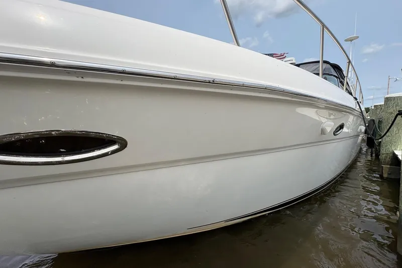 Slide: The Image of 2001 Sea Ray 460 Sundancer yacht docked, side view with sleek white hull. - 15