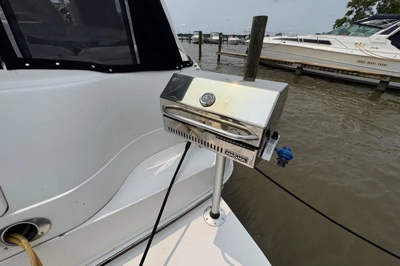 Slide: The Image of Stainless steel grill on 2001 Sea Ray 460 Sundancer yacht docked by the water. - 16