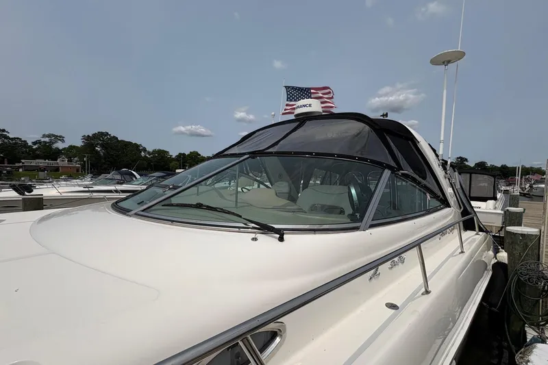 Slide: The Image of 2001 Sea Ray 460 Sundancer yacht docked with American flag in background. - 17