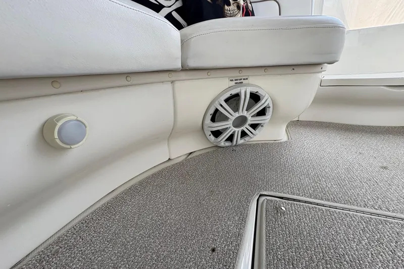 Slide: The Image of Interior of 2001 Sea Ray 460 Sundancer with speaker and light on carpeted floor. - 22