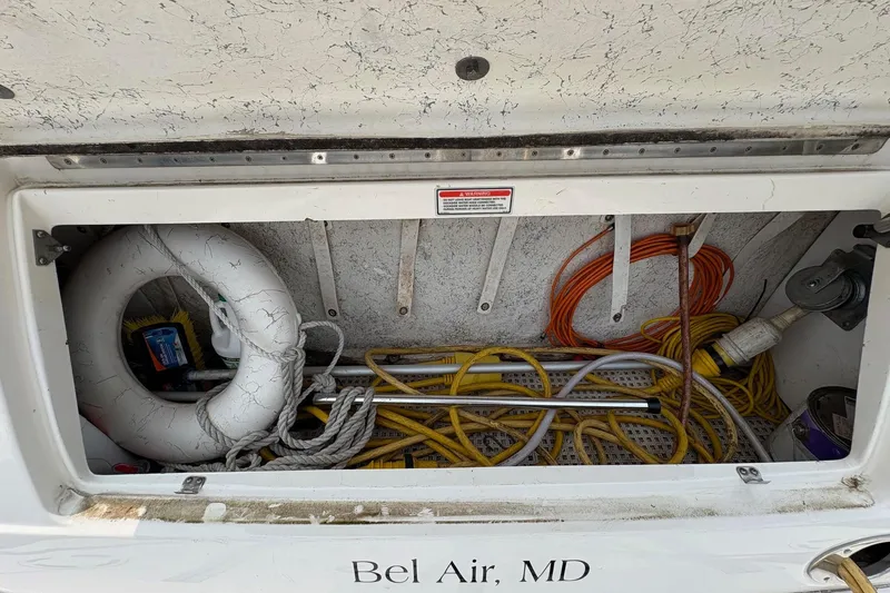 Slide: The Image of Storage compartment of a 2001 Sea Ray 460 Sundancer with ropes and life ring, Bel Air, MD. - 23