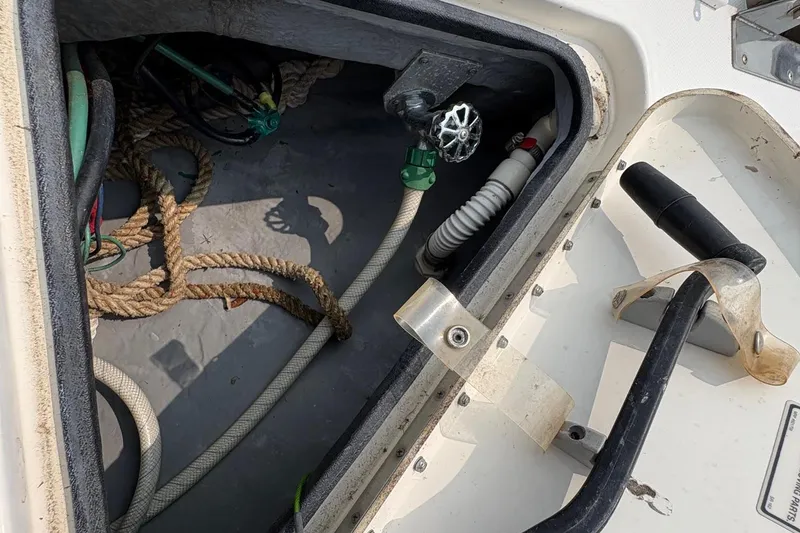 Slide: The Image of Storage compartment of a 2001 Sea Ray 460 Sundancer boat with ropes and equipment. - 24