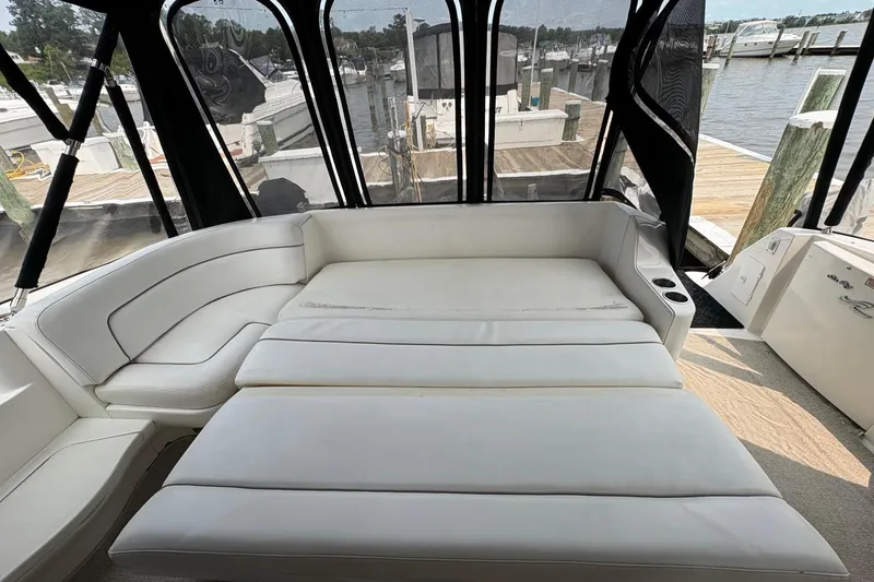 Slide: The Image of Luxurious interior of 2001 Sea Ray 460 Sundancer yacht with white seating and marina view. - 27