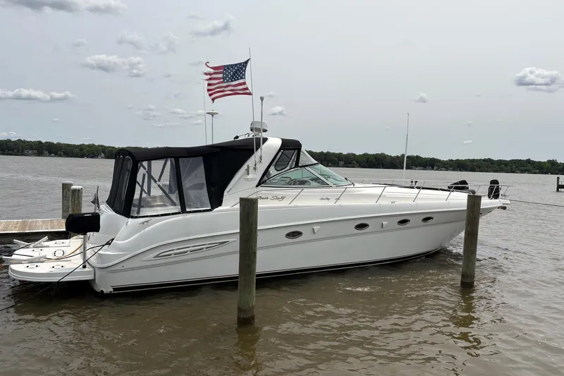 Slide: The Image of 2001 Sea Ray 460 Sundancer yacht docked with American flag waving. - 3