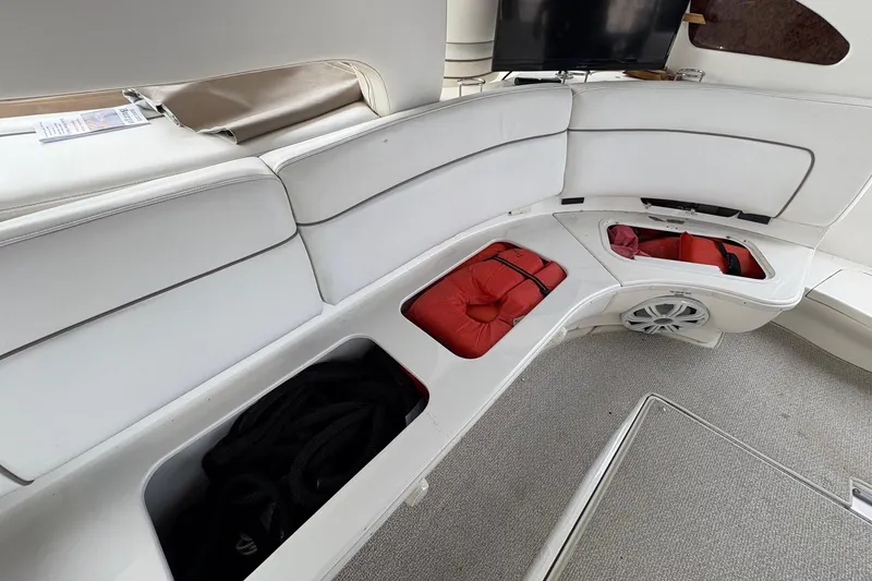Slide: The Image of Interior of 2001 Sea Ray 460 Sundancer with white seating and storage compartments. - 30