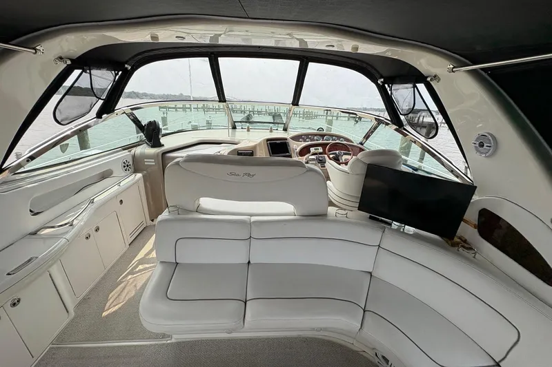 Slide: The Image of Interior of 2001 Sea Ray 460 Sundancer yacht with white seating and helm view. - 31