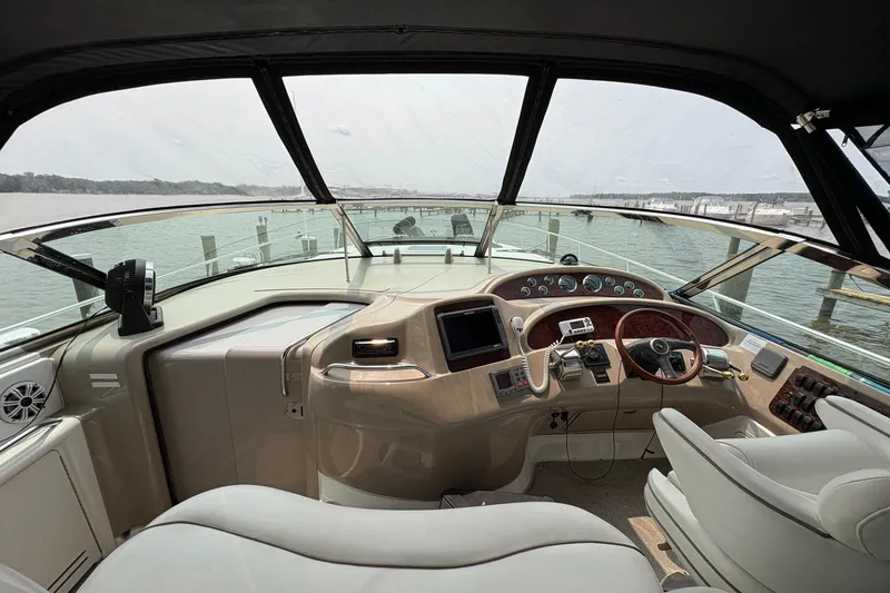 Slide: The Image of Interior view of 2001 Sea Ray 460 Sundancer yacht cockpit with steering wheel and controls. - 32