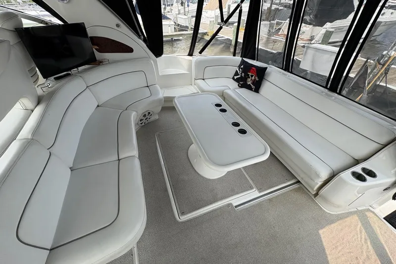 Slide: The Image of Luxurious interior of 2001 Sea Ray 460 Sundancer yacht with white seating and table. - 33