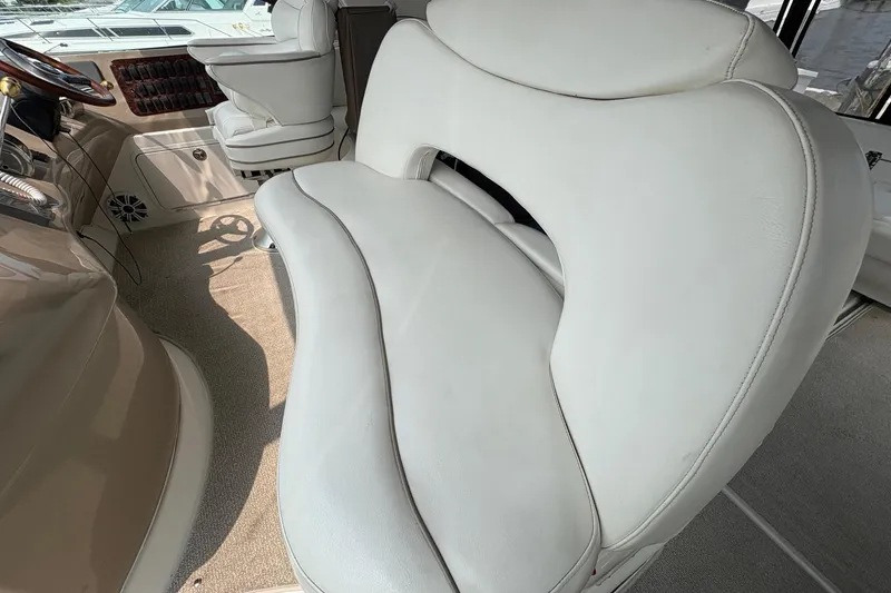Slide: The Image of Interior seating of 2001 Sea Ray 460 Sundancer yacht, featuring plush white upholstery. - 34