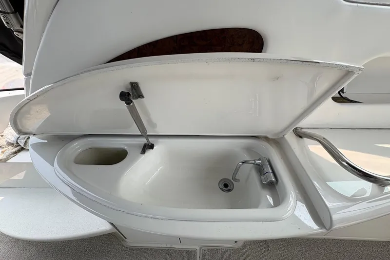 Slide: The Image of 2001 Sea Ray 460 Sundancer boat sink with open lid and faucet. - 37