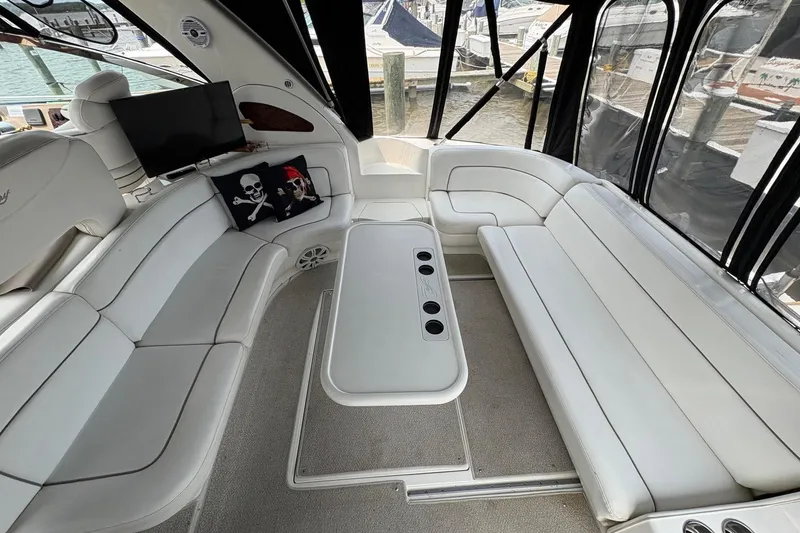 Slide: The Image of Luxurious interior of 2001 Sea Ray 460 Sundancer yacht with white seating and pirate-themed pillows. - 39