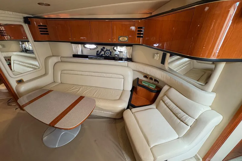 Slide: The Image of Luxurious interior of 2001 Sea Ray 460 Sundancer yacht with leather seating and wooden cabinetry. - 40