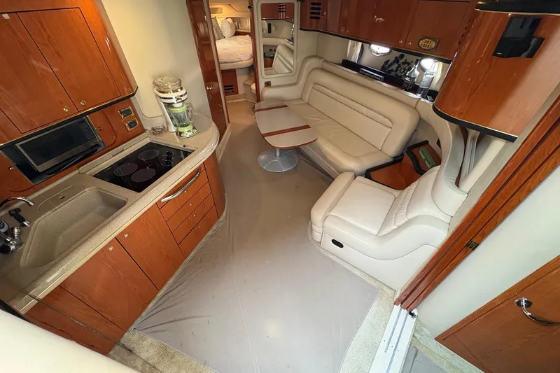 Slide: The Image of Interior of 2001 Sea Ray 460 Sundancer yacht with kitchen and seating area. - 41