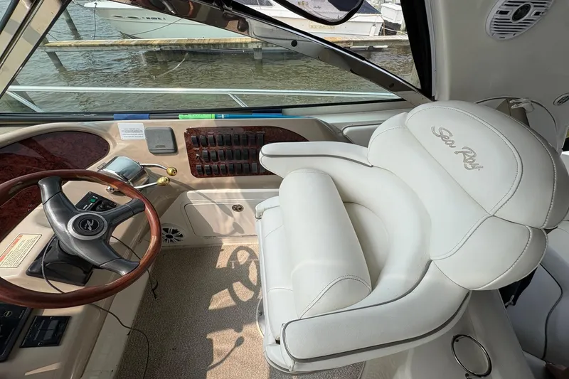 Slide: The Image of Interior of 2001 Sea Ray 460 Sundancer yacht with steering wheel and plush seating. - 42