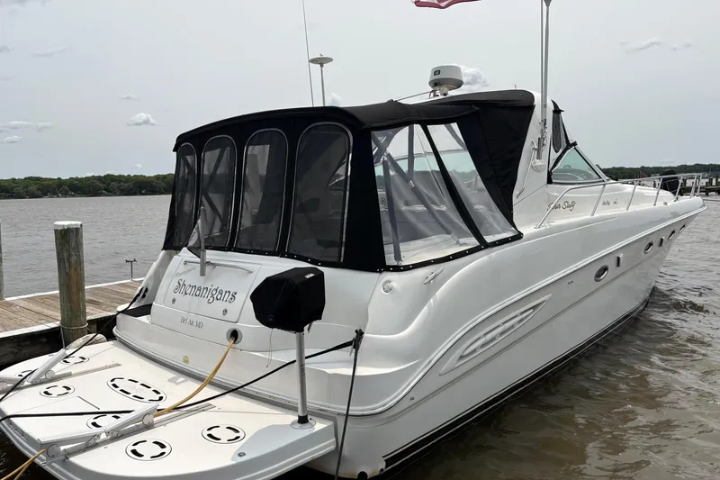 Slide: The Image of 2001 Sea Ray 460 Sundancer yacht docked at marina with black canopy. - 5