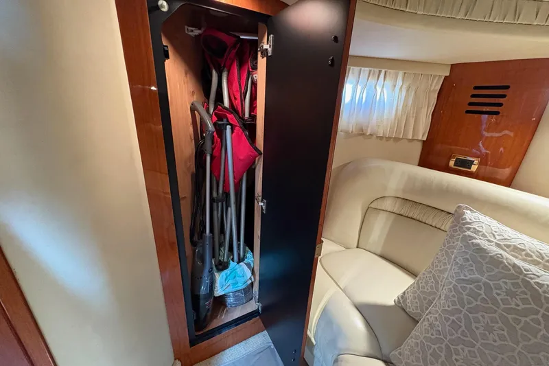 Slide: The Image of Interior of 2001 Sea Ray 460 Sundancer with open storage closet and seating area. - 50