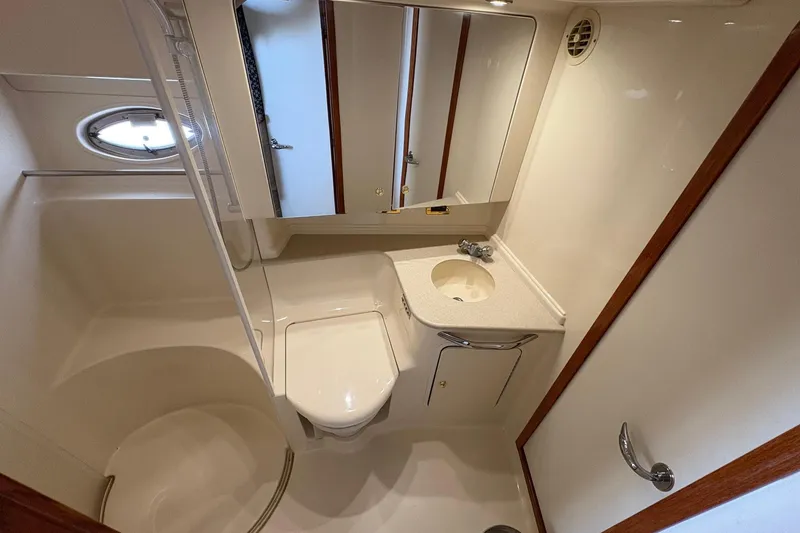 Slide: The Image of 2001 Sea Ray 460 Sundancer bathroom with shower, sink, and mirror. - 51