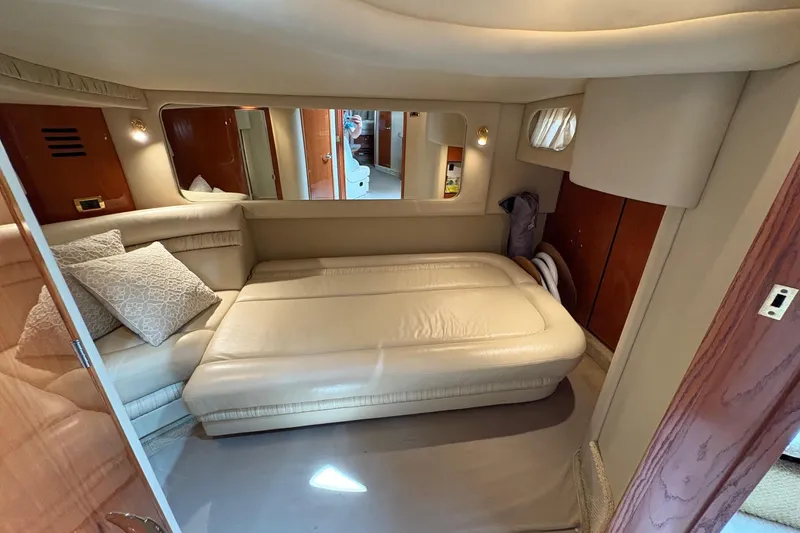 Slide: The Image of Interior of 2001 Sea Ray 460 Sundancer yacht with beige leather seating and wooden accents. - 53