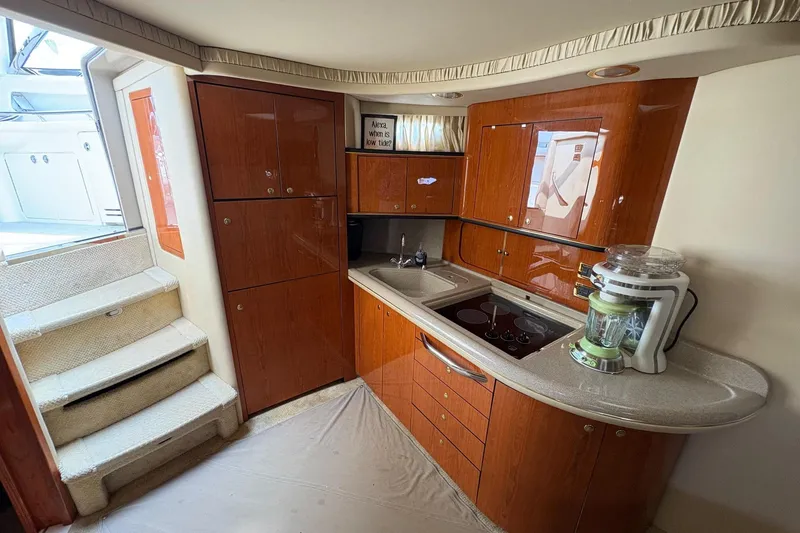 Slide: The Image of Luxurious kitchen interior of 2001 Sea Ray 460 Sundancer yacht with wooden cabinetry. - 54