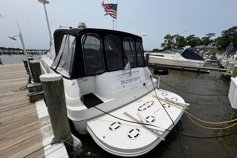 Slide: The Image of 2001 Sea Ray 460 Sundancer docked at marina with American flag. - 6